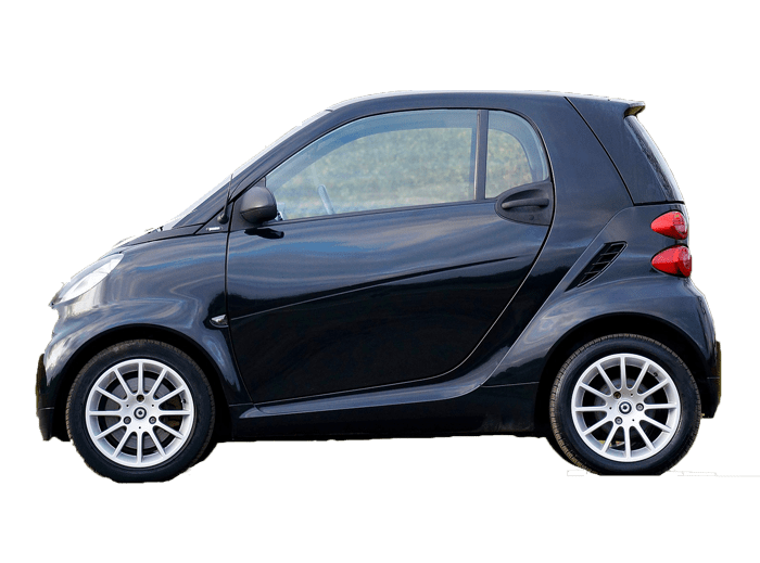 A smart car is parked on the side of the road.