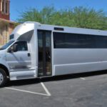 A white bus parked in the parking lot.