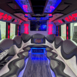 A view of the back of a bus with lights on.