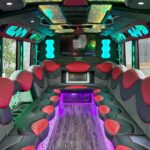 A party bus with red and purple seats.